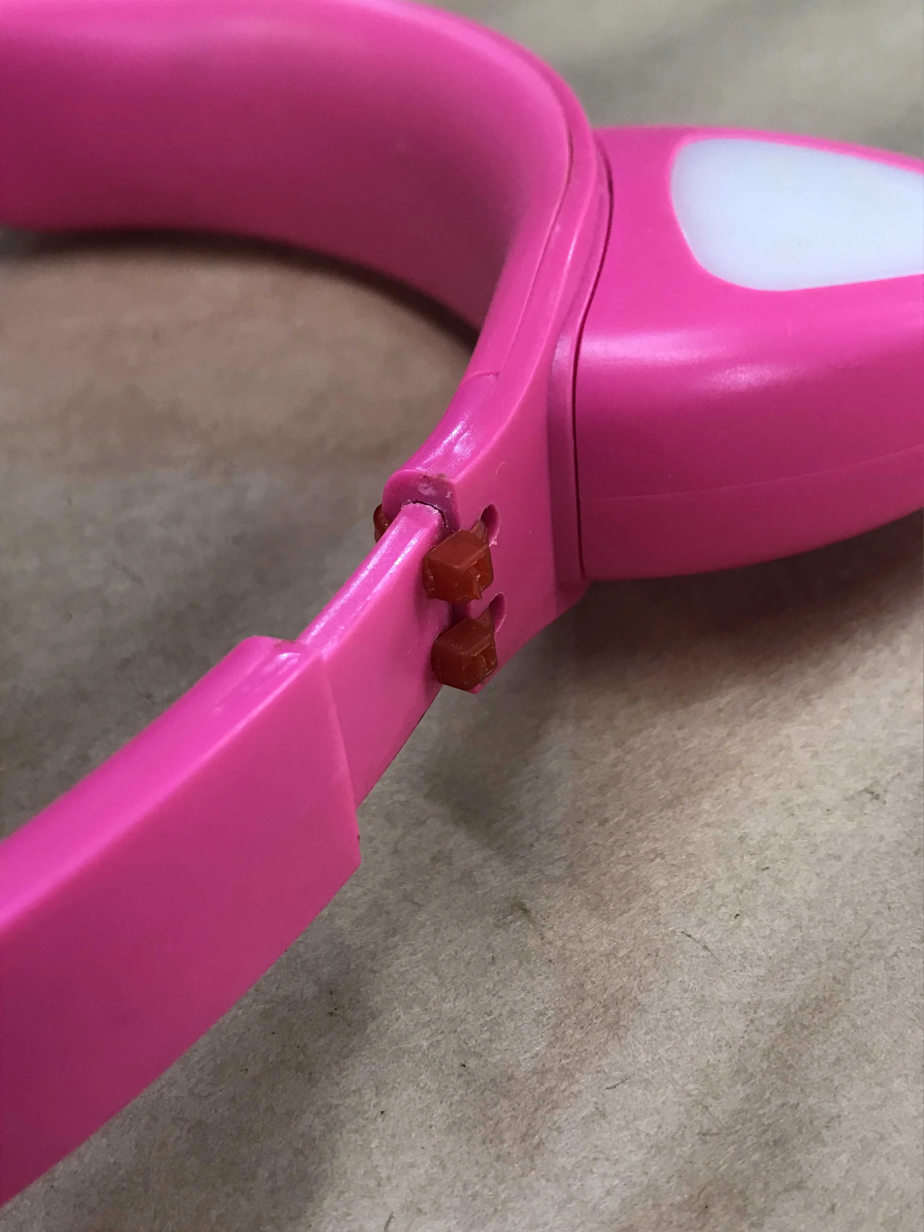 Pink headphones with zip tie